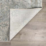 Close-up of the Gilmanton Thick Luxe Boutique Rug showing its dusty sage, gray, and beige pattern and machine-woven construction. Fold