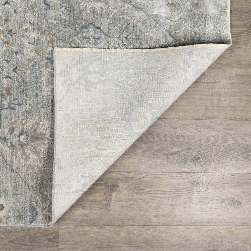 Close-up of the Gilmanton Thick Luxe Boutique Rug showing its dusty sage, gray, and beige pattern and machine-woven construction. Fold