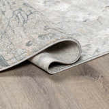 Close-up of the gray, beige, and sage Gilmanton Thick Luxe Boutique Rug showing its texture and backing. Fold