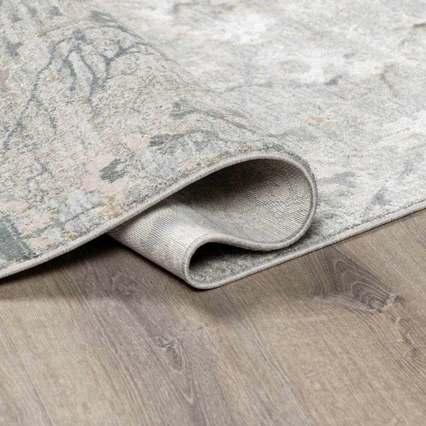 Close-up of the gray, beige, and sage Gilmanton Thick Luxe Boutique Rug showing its texture and backing. Fold