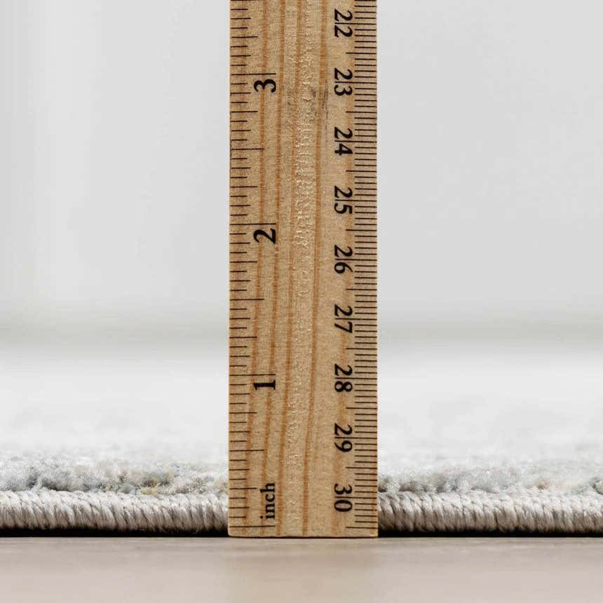 Close-up of the thick pile height of the Gilmanton Thick Luxe Boutique Rug, showing its texture and construction. Pile