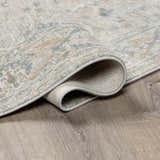 Close-up of the Glengarry Thick Luxe Boutique Rug showing its dusty sage, beige, and gray vintage pattern and texture. Fold