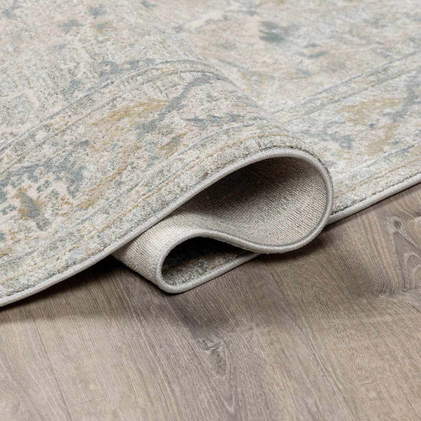 Close-up of the Glengarry Thick Luxe Boutique Rug showing its dusty sage, beige, and gray vintage pattern and texture. Fold
