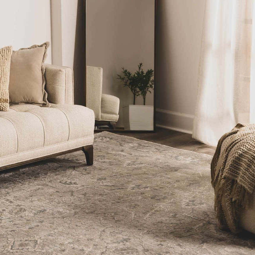 Living room scene with a beige sofa and Glengarry Thick Luxe Boutique Rug in dusty sage, beige, and gray tones. Roomscene-Rectangle