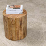 Close-up of the light brown Fetscher IV Vintage Damask Area Rug with a wood side table and books. Styleshot