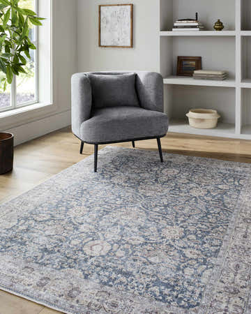 Living room scene with gray chair on Andrei Area Rug - Vivir x Livabliss in beige, blue, and dark brown. Farmhouse style. Roomscene-Rectangle