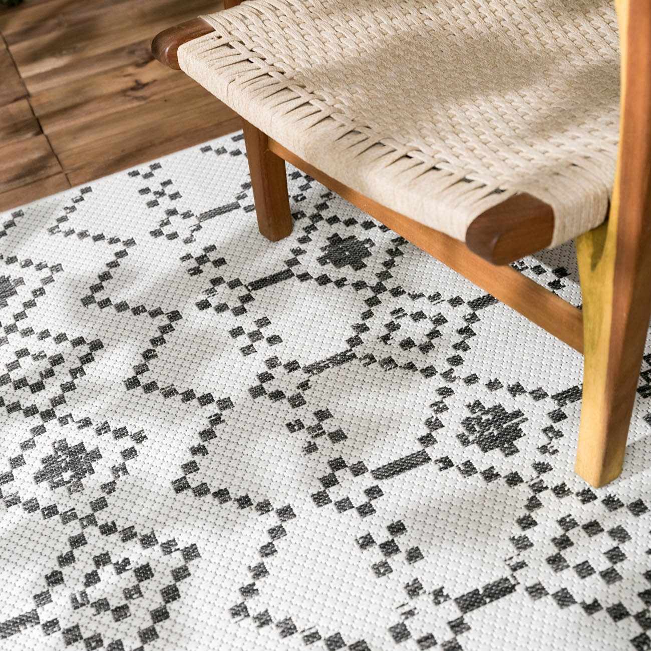 Close-up of Haynesville Moroccan Design Pixel Rug in black and white, with a geometric pattern and woven texture. Styleshot