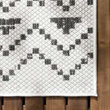 Close-up of the Haynesville Moroccan Design Pixel Rug. Black and white pixelated pattern, machine woven texture. Swatch