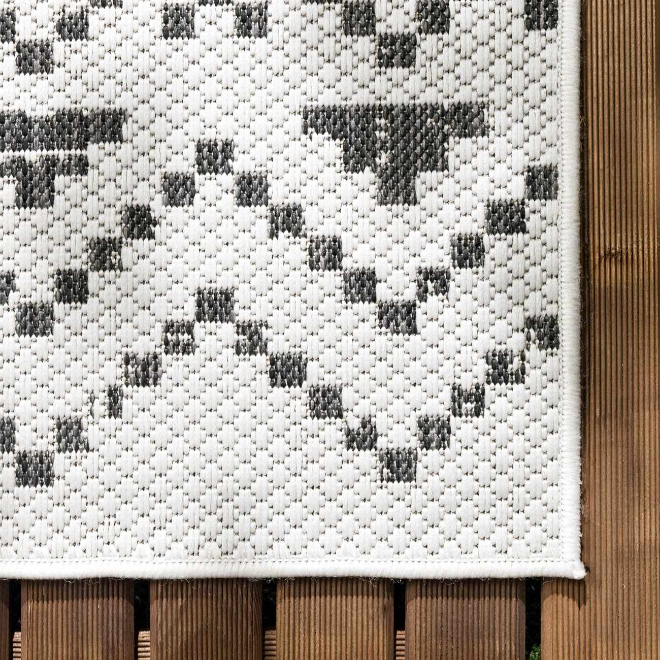 Close-up of the Haynesville Moroccan Design Pixel Rug. Black and white pixelated pattern, machine woven texture. Swatch