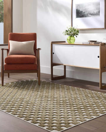 Living room scene with an Anthea Olive Washable Area Rug, orange chair, and modern white and wood console table. Roomscene-Rectangle