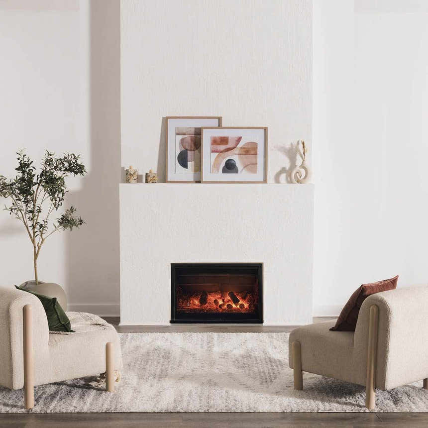 Living room scene with a gray Trunding Plush Area Rug, fireplace, and two cream-colored armchairs. Roomscene-Rectangle