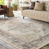 Living room scene with a beige sofa and the Hillcrest Area Rug in beige, blue, and rust colors. Roomscene-Rectangle