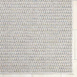 Close-up of the Ataret Ivory Area Rug showing its woven texture and ivory, tan, and blue color palette. Corner