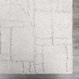 Close up of the plush, cream Andia Grid Rug with a subtle geometric pattern. Swatch