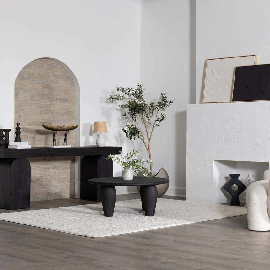 Minimal living room scene with a cream Andia Plush Grid Rug, black furniture, and neutral decor. Roomscene-Rectangle