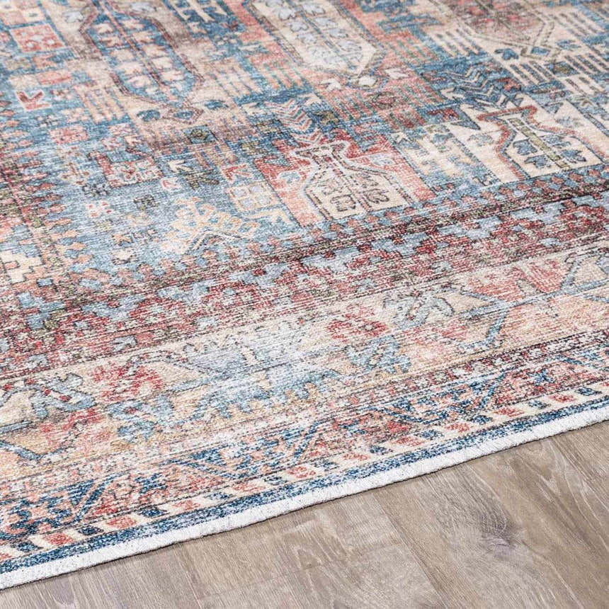 Close-up of the Holi-2300 Boutique Washable Rug. Aqua, burnt orange, and light gray vintage-style pattern. Corner
