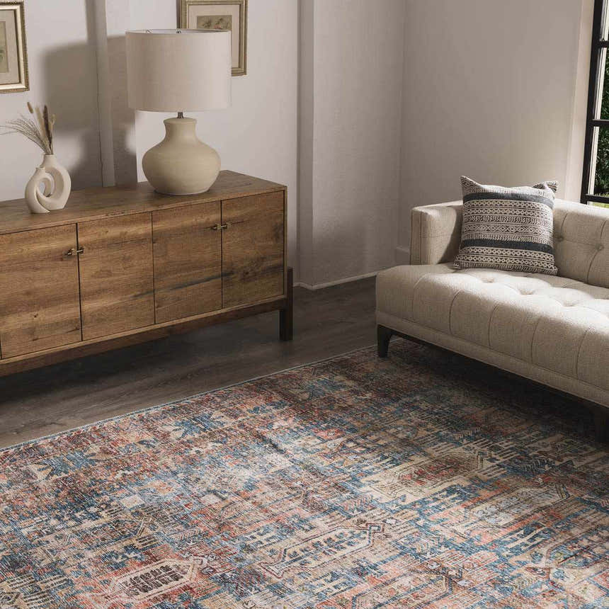 Living room scene with a Holi-2300 Boutique Washable Rug. Aqua, orange, and gray rug complements the neutral sofa and wood cabinet. Roomscene-Rectangle