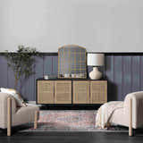 Living room scene with a Blue Burgundy Holi-2302 rug, beige chairs, and a wood cabinet with a mirror. Roomscene-Rectangle