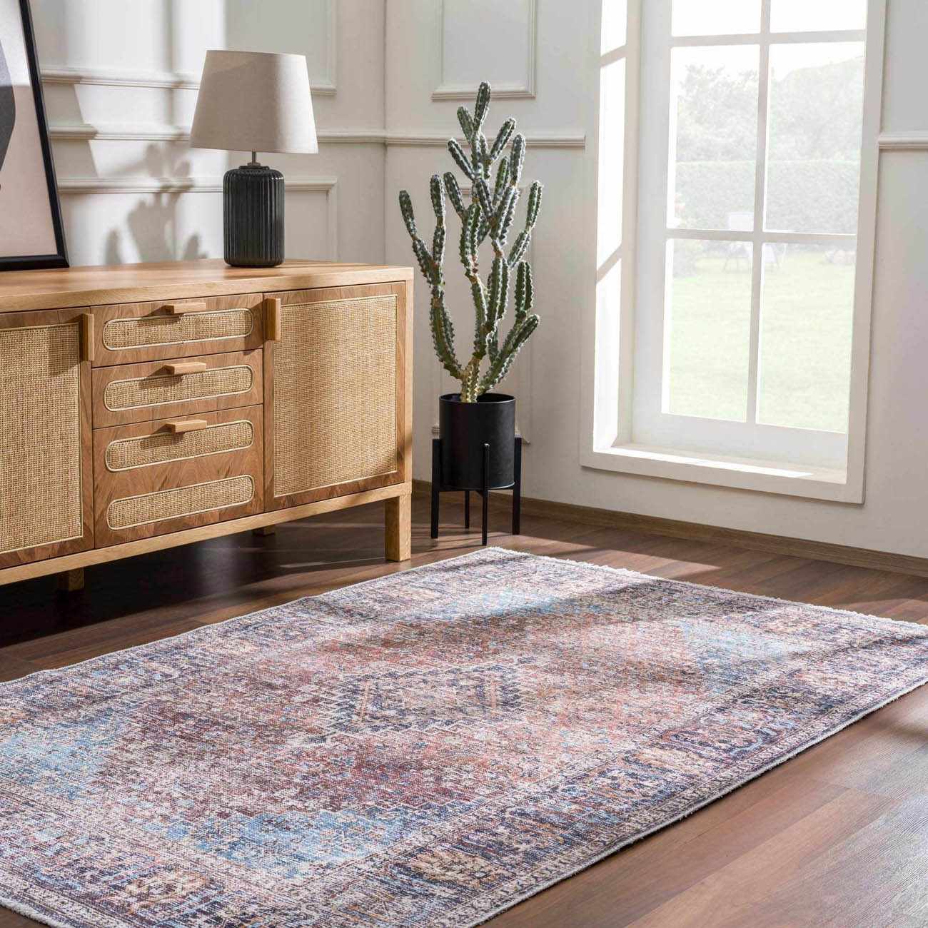 Living room scene with a Blue Burgundy Holi-2302 washable rug, wood cabinet, lamp, and cactus near a window. Roomscene-Rectangle