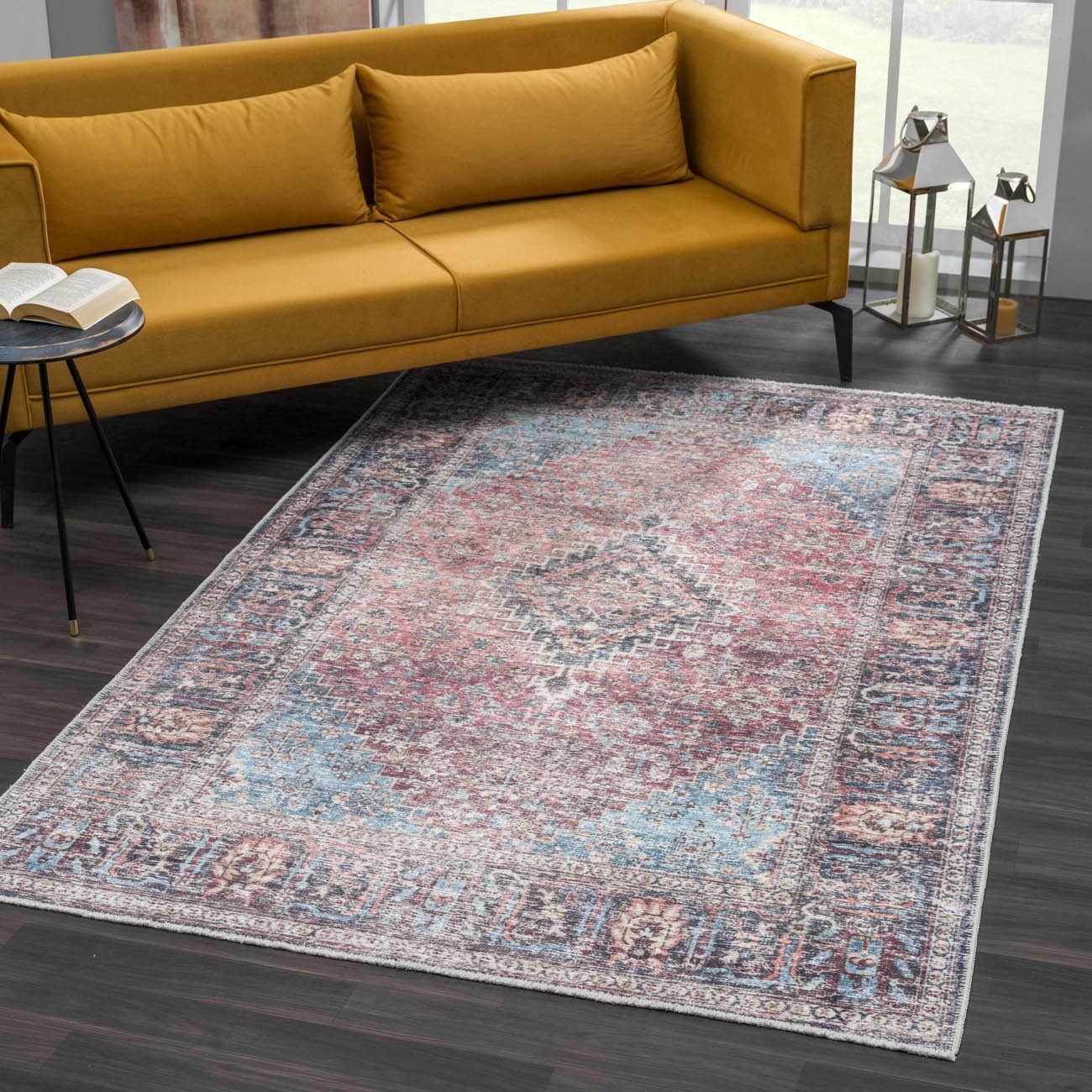 Living room scene with a Blue Burgundy Holi-2302 Washable Area Rug, yellow sofa, dark wood floors, and natural light. Roomscene-Rectangle