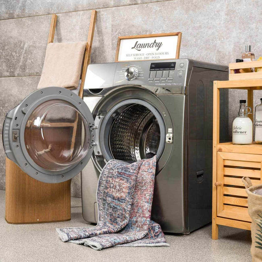 Laundry room scene with Blue Burgundy Holi-2302 Washable Area Rug partially inside a front load washing machine. Washing-Machine