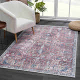 Living room scene with a Burgundy Holi-2303 Washable Area Rug, cream chair, and dark wood floors. Vintage style. Roomscene-Rectangle