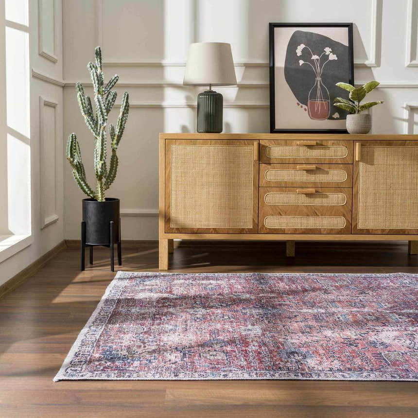 Living room scene with a Burgundy Holi-2303 Washable Area Rug, wood floors, and a light wood cabinet. Cactus and modern art add style. Roomscene-Rectangle