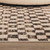 Close-up of the Benjy Cream & Charcoal Checkered Area Rug showing the contemporary checkered design and soft texture. Roomscene-Rectangle
