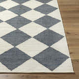 Close-up of the hand woven Andrin Gray Area Rug. Beige and steel gray checkered pattern. Jute texture. Front