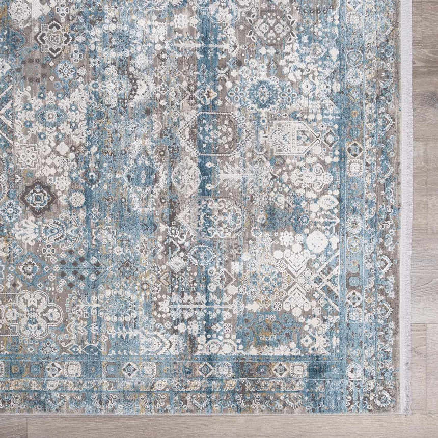 Close-up of the Hartsel Area Rug featuring a traditional pattern in charcoal, dark blue, gray, and mustard tones. Swatch
