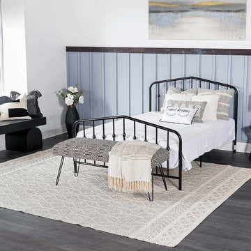 Bedroom scene with a black metal bed frame and the light gray Carolina Wool Area Rug. Roomscene-Rectangle
