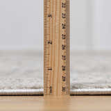 Close up of the New Parkerfield area rug pile height, with a ruler showing the thickness. Pile