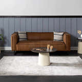 Living room scene with a brown leather sofa and beige Parkerfield Area Rug. Roomscene-Rectangle