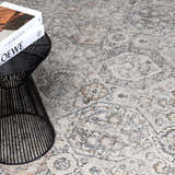 Close-up of the Parkerfield Area Rug showing its beige, black, and gray traditional vintage pattern and soft texture. Styleshot