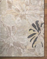 Close-up of the Ilfeld Athena Gray Floral Wool Rug, featuring charcoal, brown, and gray floral pattern and hand-tufted texture. Corner