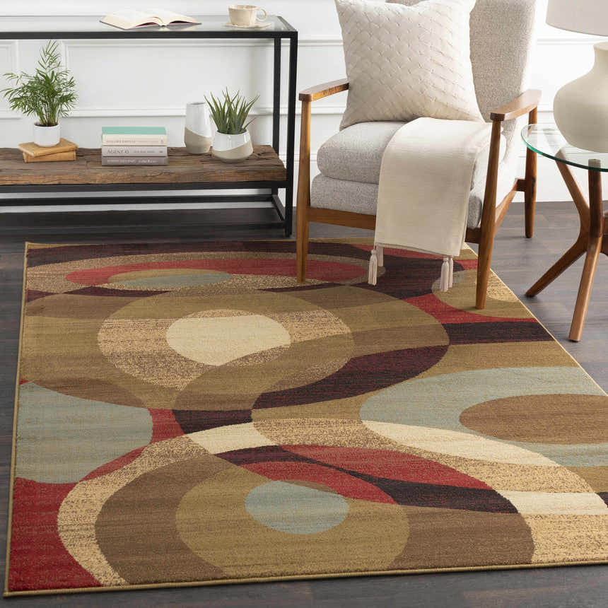 Living room scene with a mid-century chair on a geometric Jackhorn Area Rug in brown, red, green, and blue. Roomscene-Rectangle