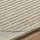 Close up of the Ecru Abstract Modern Hand Tufted Wool Area Rug showing its textured, striped design and wool fibers. Texture