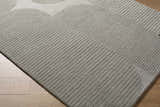 Close-up of Fixui Gray Abstract Area Rug. Hand-tufted wool rug with subtle linear pattern and geometric details. Corner