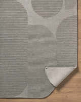 Close-up of Fixui Gray Abstract Rug. Hand-tufted wool rug with ash gray, charcoal, and slate gray circle pattern. Fold