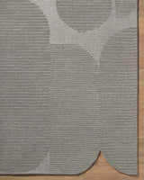 Close-up of the Fixui Gray Abstract Area Rug showing its textured, hand-tufted wool and contemporary circle design. Corner