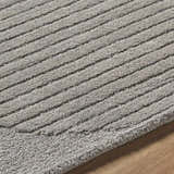 Close-up of the Fixui Gray Abstract Area Rug. Hand-tufted wool rug with a textured, striped pattern in ash gray tones. Texture