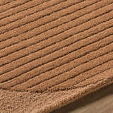 Close up of the Fihe Abstract Modern Rug showing the hand tufted wool texture and ribbed design in terracotta. Texture