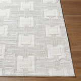 Close-up of the cream and ivory Jackie Area Rug, featuring a contemporary square pattern and machine-woven texture. Front