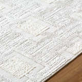 Close up of the Jackie Area Rug. Cream, ivory, and white geometric pattern with textured pile. Texture
