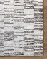 Close up of the Apphia Area Rug showing ivory and light brown horizontal stripe pattern. Corner