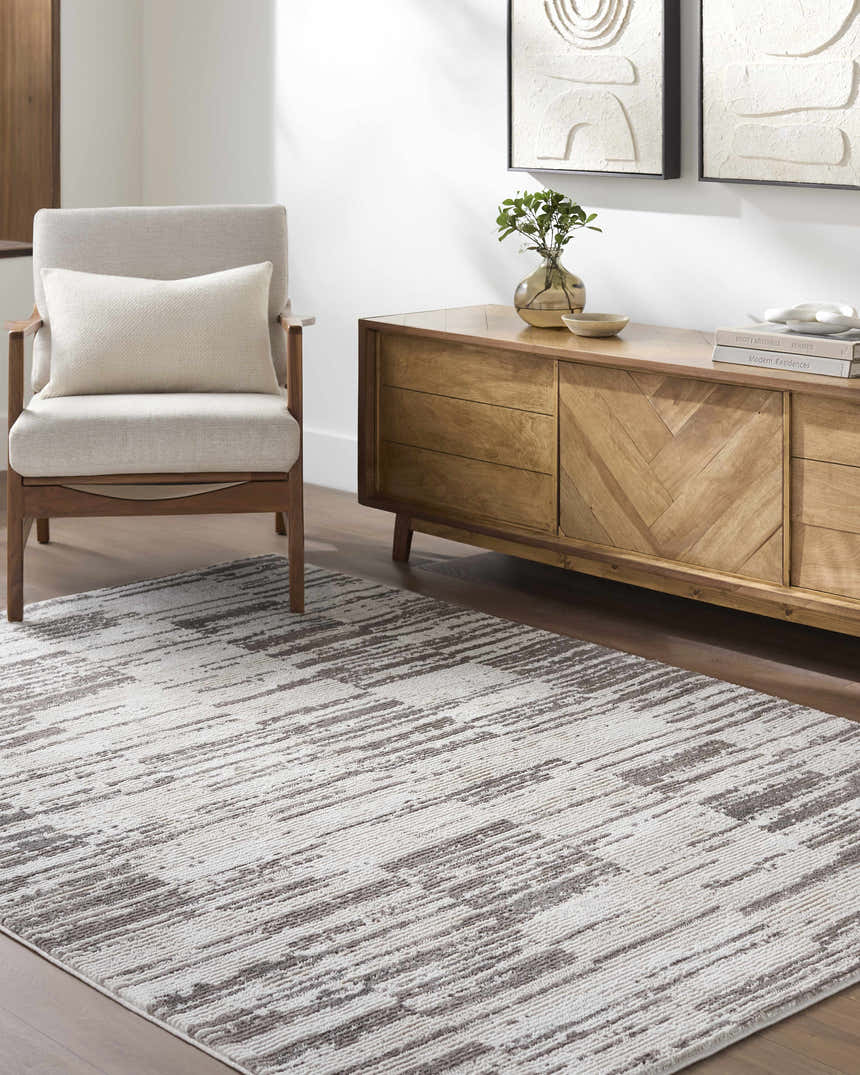 Living room scene with ivory and light brown Apphia Area Rug, light wood furniture, and neutral decor. Roomscene-Rectangle