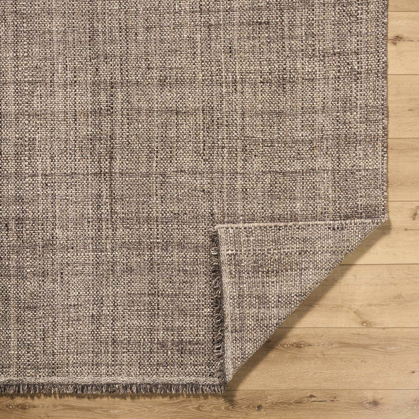 Close-up of the hand woven Pufoe Modern Wool Area Rug showing texture and detail on a wood floor. Fold