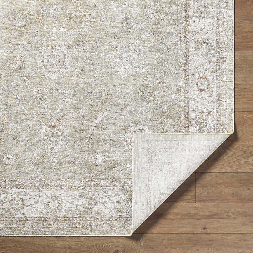 Close-up of the machine-woven Ashraf Area Rug. Farmhouse style, traditional pattern, neutral colors, polyester texture. Fold