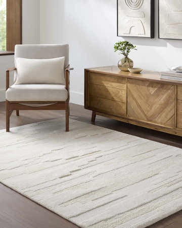Living room scene with a cream Anufry Area Rug, mid-century wood chair, and console table with modern art. Roomscene-Rectangle