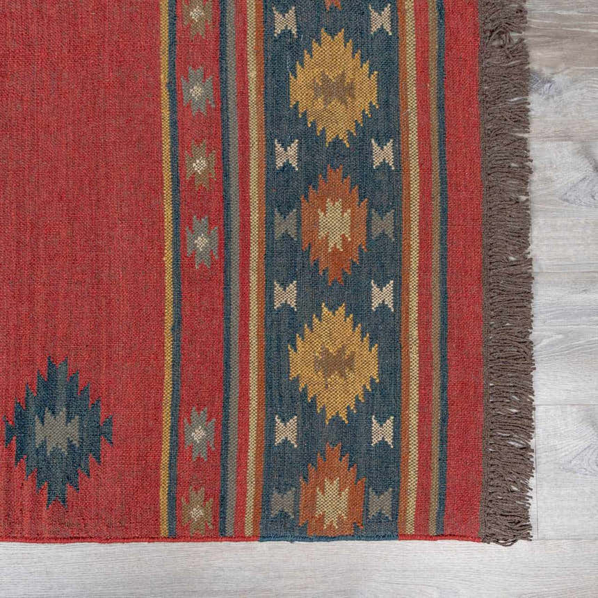 Close-up of the hand-woven Hedon Wool Area Rug. Brick red, camel, and navy colors with a Southwestern geometric pattern. Swatch